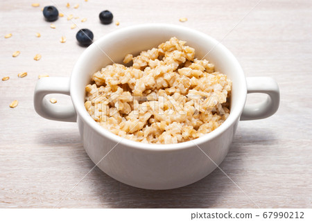 Healthy breakfast oatmeal porridge with 67990212