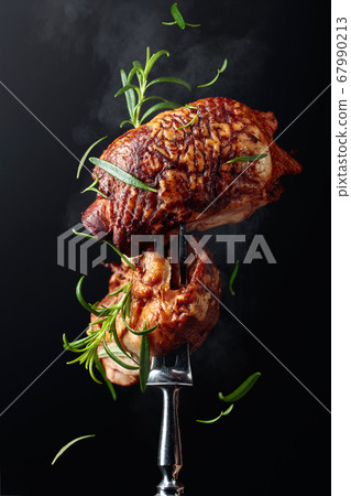 Tasty smoked chicken  thighs with rosemary on a 67990213