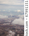View from the porthole of an airplane. Clouds over Lisbon. 67991151