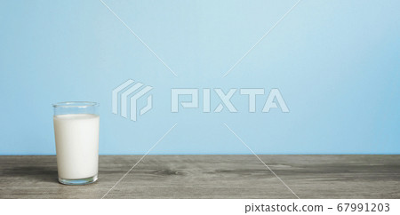 A glass of milk on the table 67991203