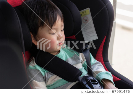 Child sleeping in a child seat 67991476