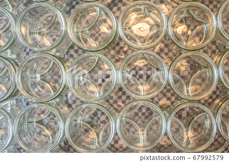 many glass jar empty glasses row for jam honey with lid caps abstract background bokeh 67992579