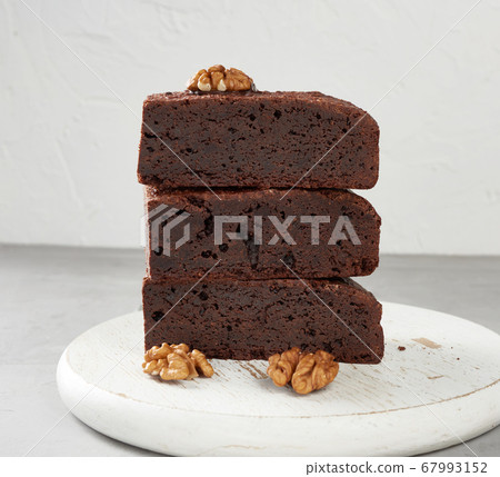 stack of baked pieces of brownie chocolate cake 67993152