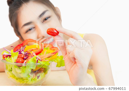 Young beautiful asian woman looking  a salad glass cup smile isolated on white background 67994011