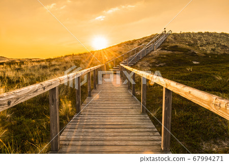 Sylt island wooden stairs at sunrise. Golden hour 67994271