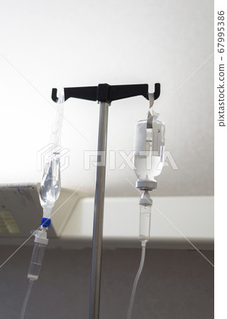 Dark image of a IV drip bags in a hospital room 67995386