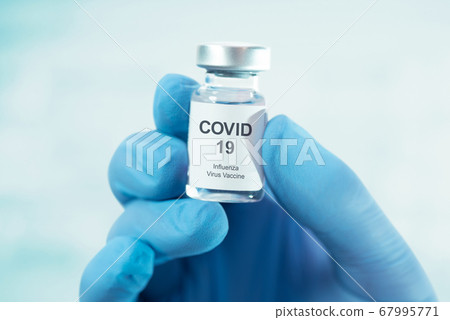 Doctor holding Covid-19 vaccine bottle 67995771