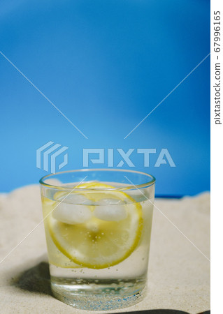 transparent glass with ice and sparkling water on 67996165