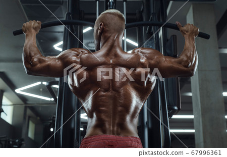 fitness man doing pull-ups exercises 67996361