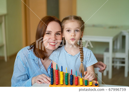 mom with girl learning to add and subtract 67996739