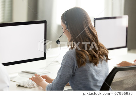 Call center operator using computer, looking at screen mock up Call center operator using computer, looking at screen mock up 67996983