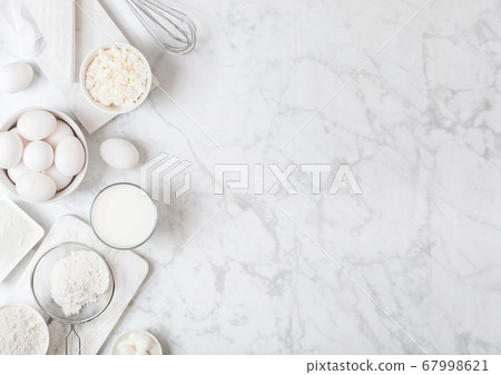 Fresh dairy products on white marble background. 67998621