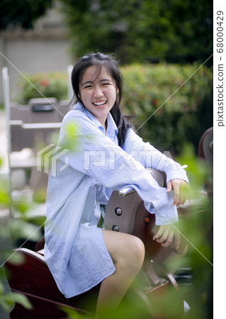 happiness asian teenager relaxing in public park 68000429