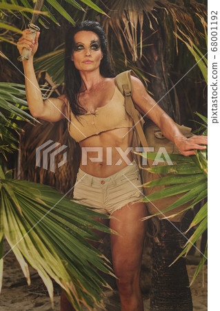 Athletic woman holding machete posing outdoor Athletic woman holding machete posing outdoor 68001192