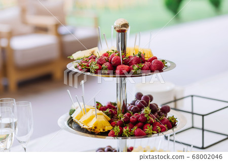 Different fruits and light snack on tray Different fruits and light snack on tray 68002046