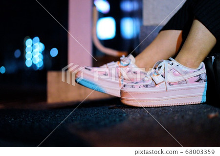 Woman in cold night and wearing sneakers Woman in cold night and wearing sneakers 68003359