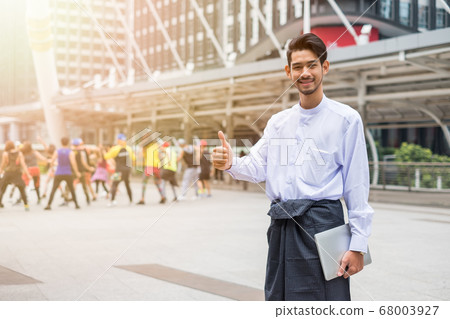 Handsome beard man stand holding laptop with hand Handsome beard man stand holding laptop with hand 68003927