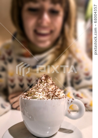 Beautiful woman drinking a cup of coffee 68004357