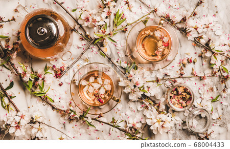 Flat-lay black tea with dry rose flowers over 68004433