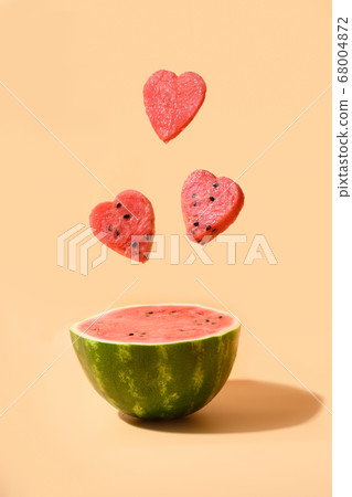 Half of watermelon flying hearts under beige  68004872
