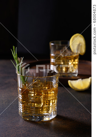 Two glasses of cold whiskey with rosemary 68004873
