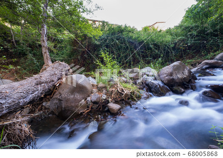 Pure water stream flowing over rocky mountain Pure water stream flowing over rocky mountain 68005868