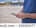 Teenage Boy Using Phone In Urban Setting 68006877
