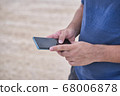 Teenage Boy Using Phone In Urban Setting 68006878