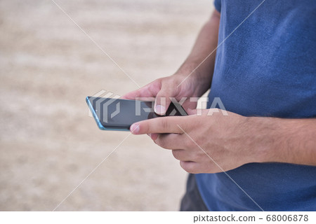 Teenage Boy Using Phone In Urban Setting 68006878
