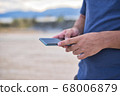 Teenage Boy Using Phone In Urban Setting 68006879
