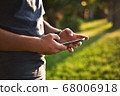 Teenage Boy Using Phone In Urban Setting 68006918