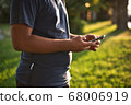 Teenage Boy Using Phone In Urban Setting 68006919