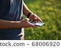 Teenage Boy Using Phone In Urban Setting 68006920
