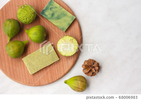 Natural green soap with Fig extract and osage apple, natural antioxidants and fruit, top view with space 68006983