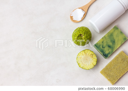 Green natural soap from the fruit of Chinese orange or osage orange and a bottle for cream, copy space, top Green natural soap from the fruit of Chinese orange or osage orange and a bottle for cream, copy space, top 68006990