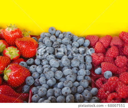 strawberries, raspberries and blueberries on 68007551