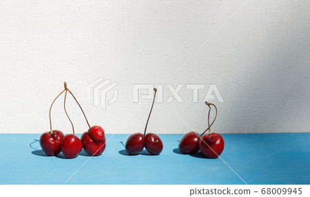 different types of funny cherries with ugly growths, fused, on a blue background, with space, horizontally different types of funny cherries with ugly growths, fused, on a blue background, with space, horizontally 68009945