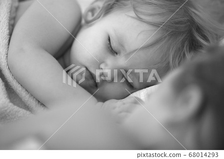 little girl with sister sleep together in bed home little girl with sister sleep together in bed home 68014293