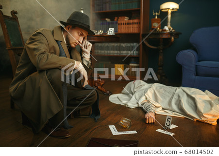 Male detective in gloves thinks at the crime scene 68014502