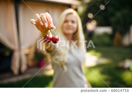 Table setting, tea party, woman shows cherries 68014758