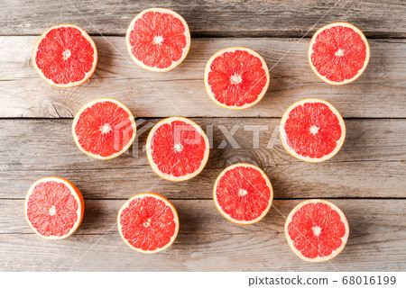 Grapefruit halves on wooden table. Top view Grapefruit halves on wooden table. Top view 68016199