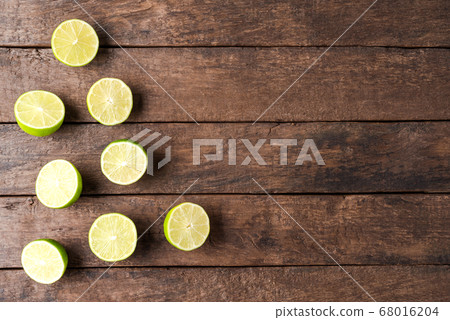 Overhead shot of limes on wooden table Overhead shot of limes on wooden table 68016204