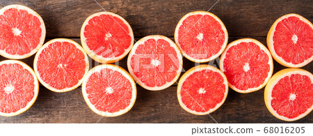 Juicy grapefruit slices on wooden table Juicy grapefruit slices on wooden table 68016205