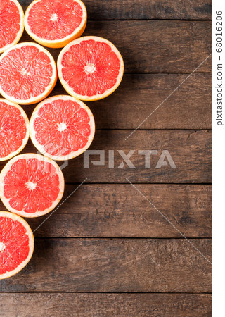 Grapefruit slices on wooden table 68016206