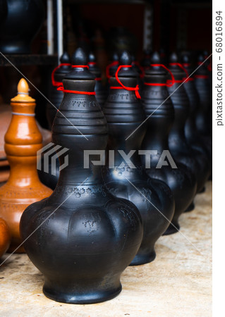 Showcase with clay pots from handmade jugs. Asian Showcase with clay pots from handmade jugs. Asian 68016894