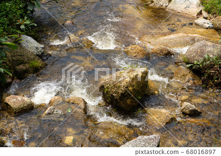 Mountain river flowing over the stones. Wildlife Mountain river flowing over the stones. Wildlife 68016897