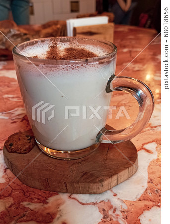 Turkish traditional winter drink salep with cinnemon powder into the glass cup on the marble table Turkish traditional winter drink salep with cinnemon powder into the glass cup on the marble table 68018656