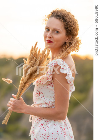 Beautiful tender girl in a white sundress walks at Beautiful tender girl in a white sundress walks at 68018990