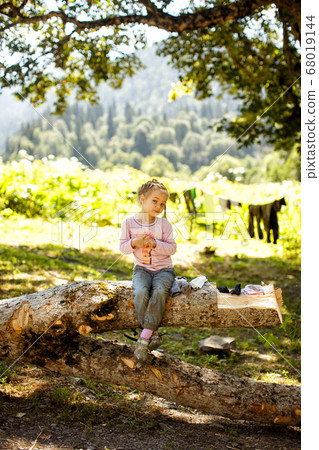 little girl sit in mountains on tree campground little girl sit in mountains on tree campground 68019144