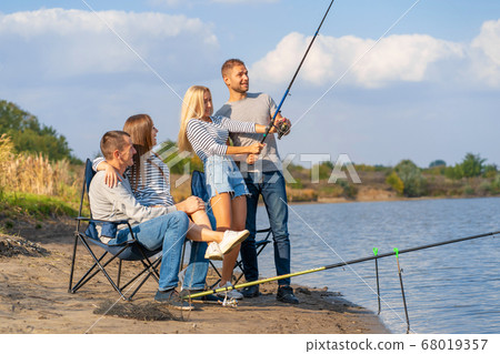 Group of young friends fishing on the pier by 68019357